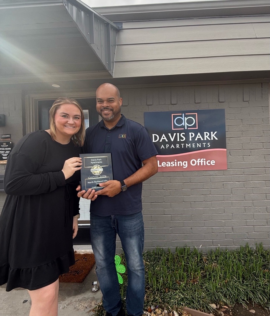 Davis Park Apartments team holding a community award outside the leasing office in North Richland Hills