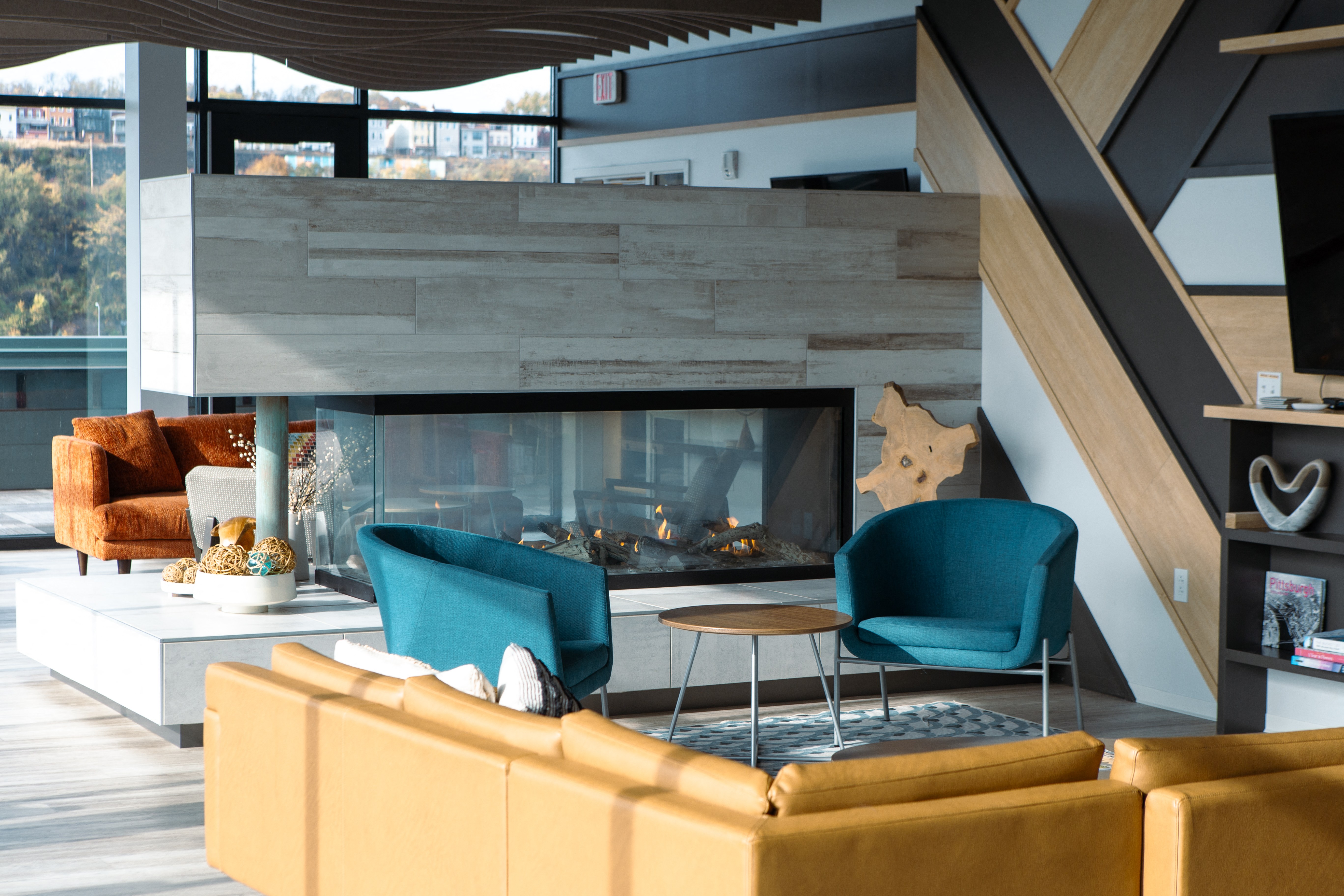 a living room with couches and chairs and a fireplace
