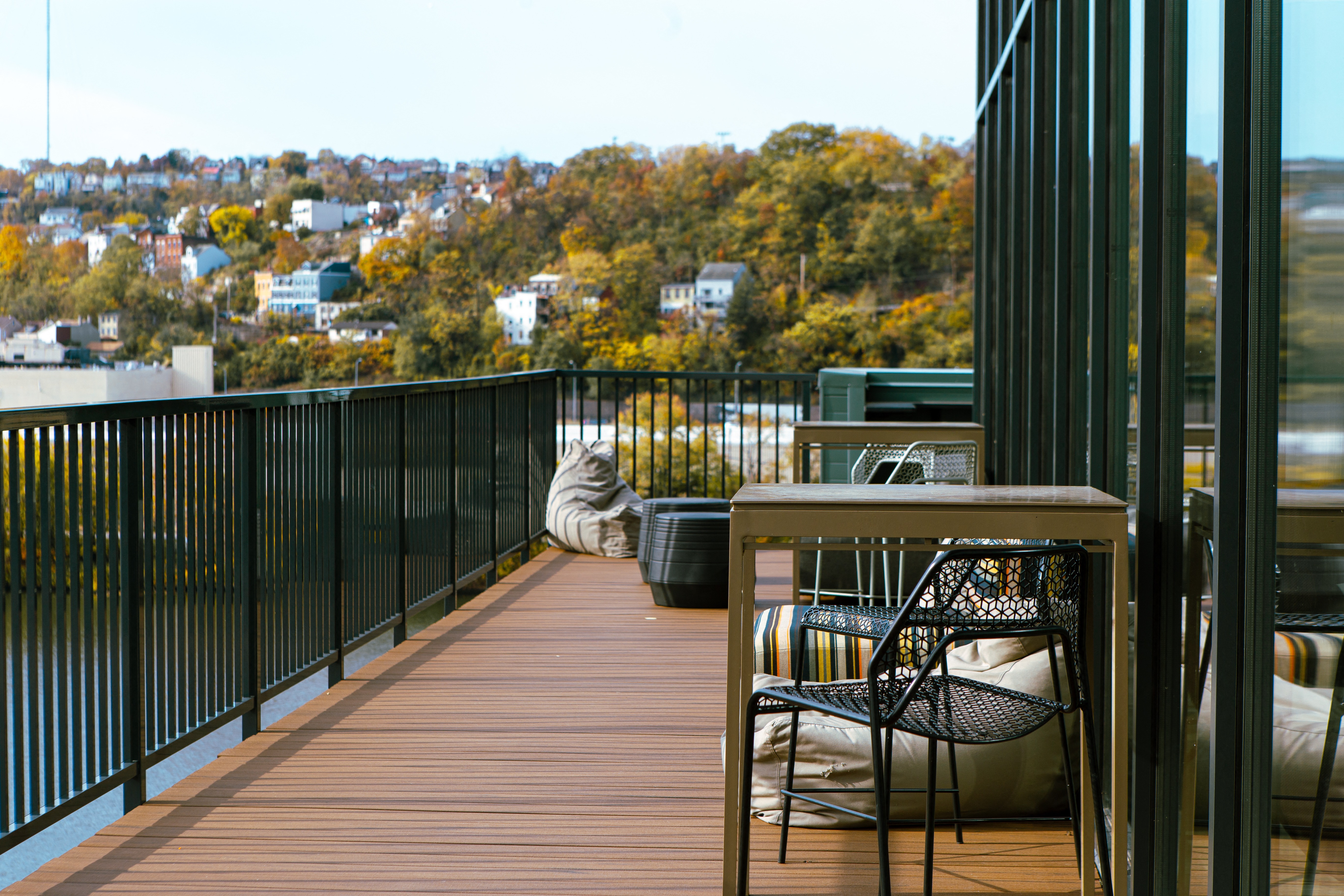 a deck with chairs and a table on a balcony