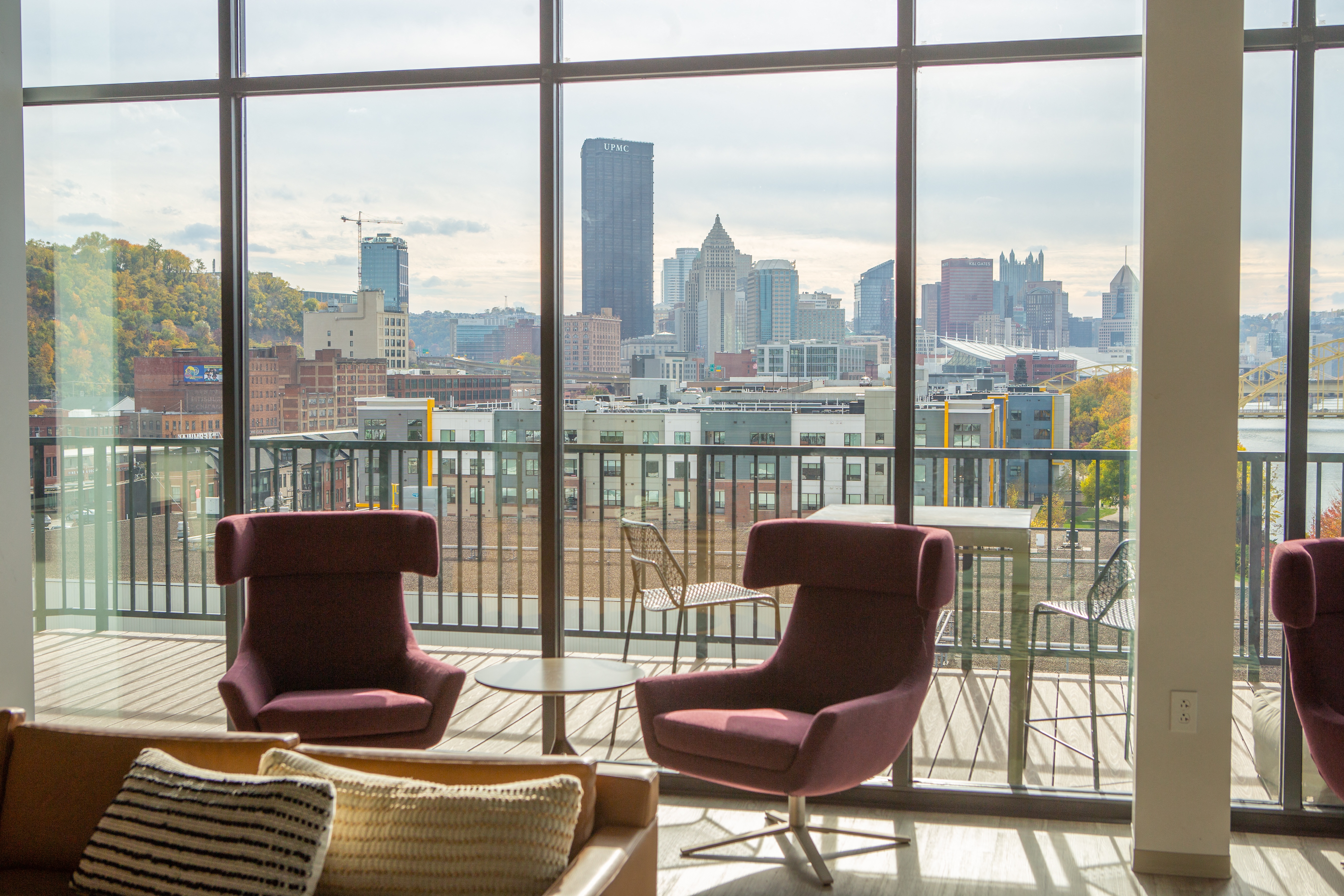 a living room with two chairs and a view of the city