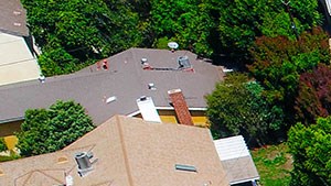 Aerial drone picture of the building showing solar panels and white energy-efficient roof.