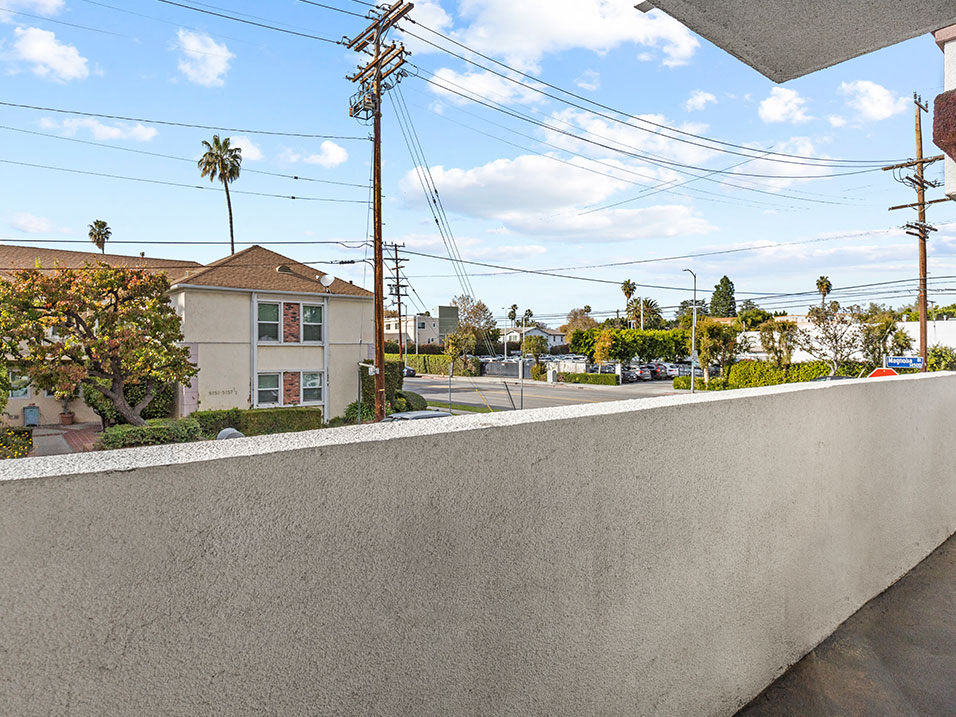 Private balcony with view of neighborhood.