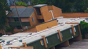 Aerial view of the courtyard, pool, jacuzzi, and solar panels.