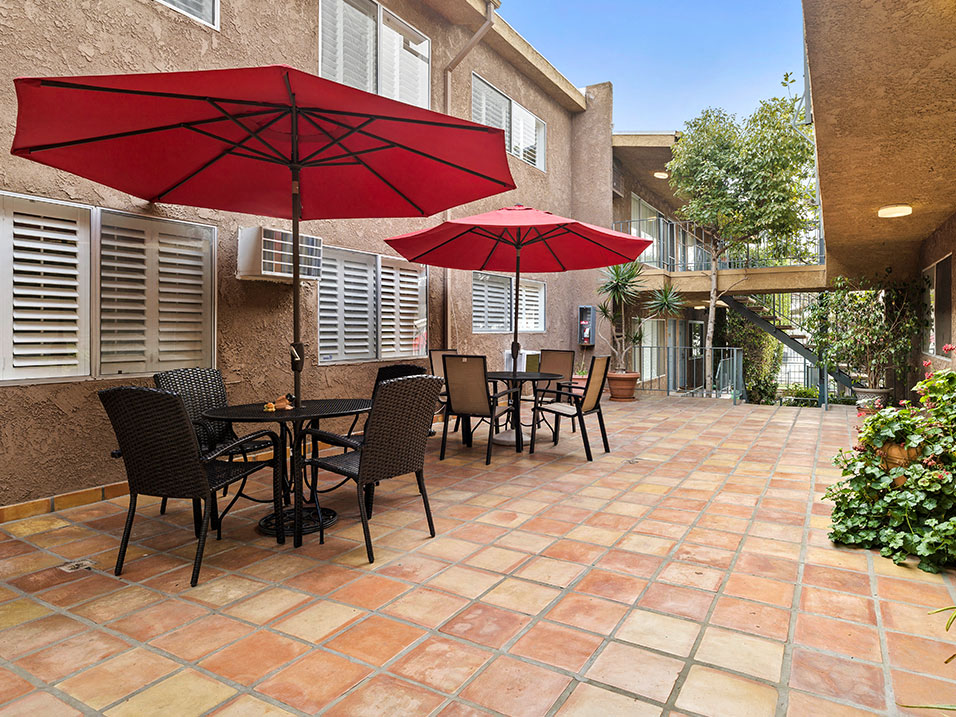 Community courtyard with picnic seating and Spanish tile.