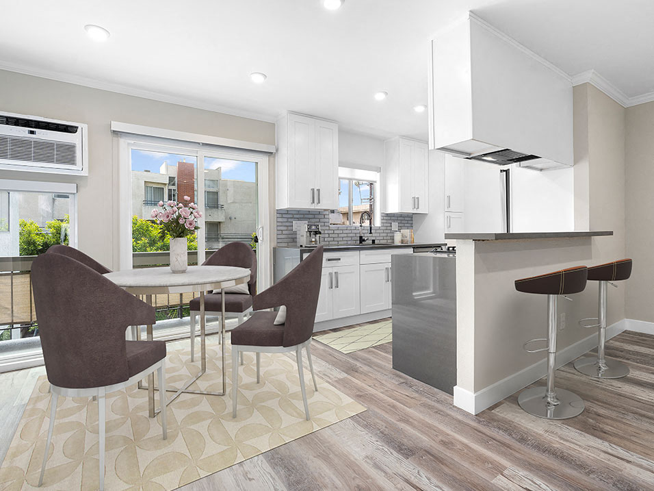 Hardwood floored dining room near bar seating in kitchen.