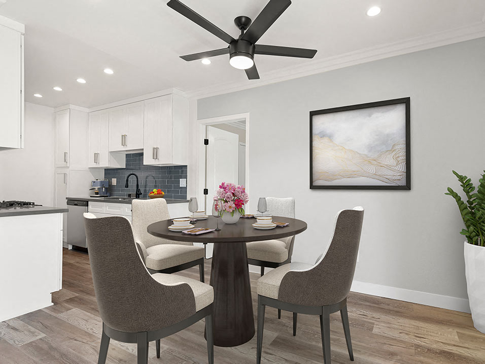 Dining room with hardwood floors, ceiling fan, and view of modern kicthen.