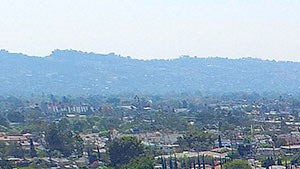 Aerial drone photo of 10620 NoHo showing solar panels and energy-efficient white roofing.