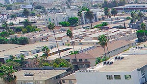 Over head drone shot of building with solar panels on roof.