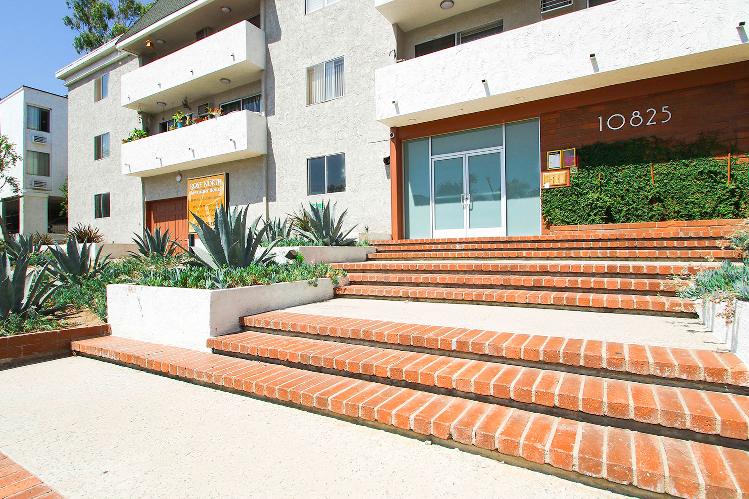 Drought-tolerant landscaping at entrance to Rose North Apartments.