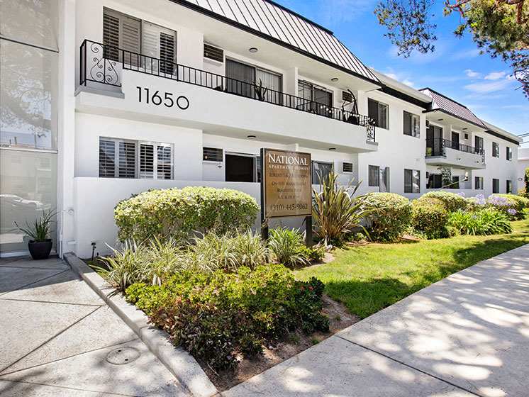 Entrance to National Apartments with drought-resistant greenery.