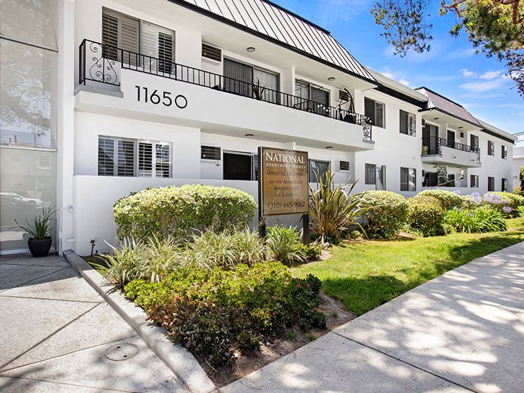 Entrance to National Apartments with drought-resistant greenery.