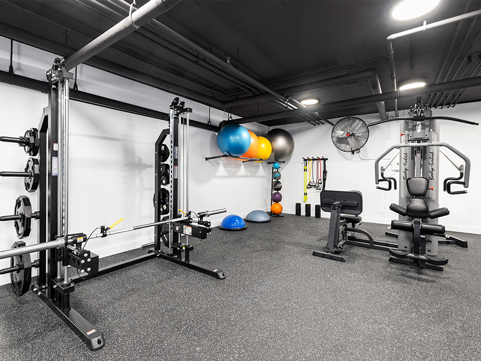 Fitness center Including cycling bikes, ellipticals, treadmills, free weights, and stretching balls.