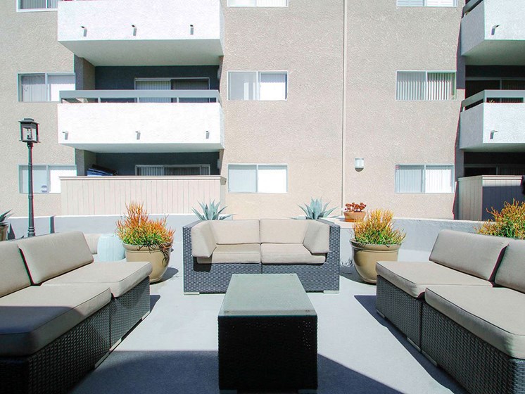 Community courtyard featuring barbecue and seating area.