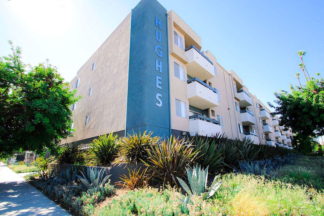 Exterior front of building showing landscaping and freshly painted building colors.
