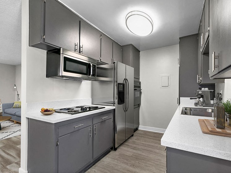 Spacious kitchen with stainless steel fridge, oven, and microwave.