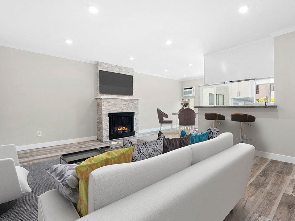 Hardwood floored living room with stone accented fireplace.
