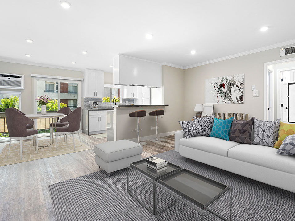 Hardwood floored living room with view of dining room, bar seating in kitchen, and balcony.