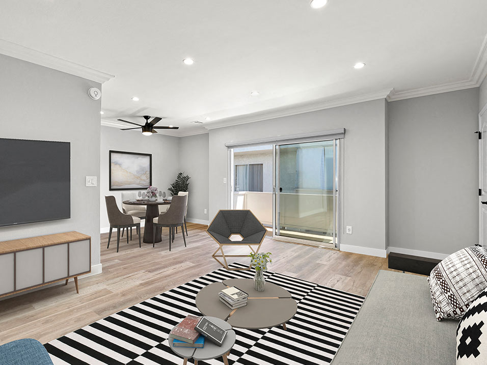 Hardwood floored living room with view of sliding door to private balcony.