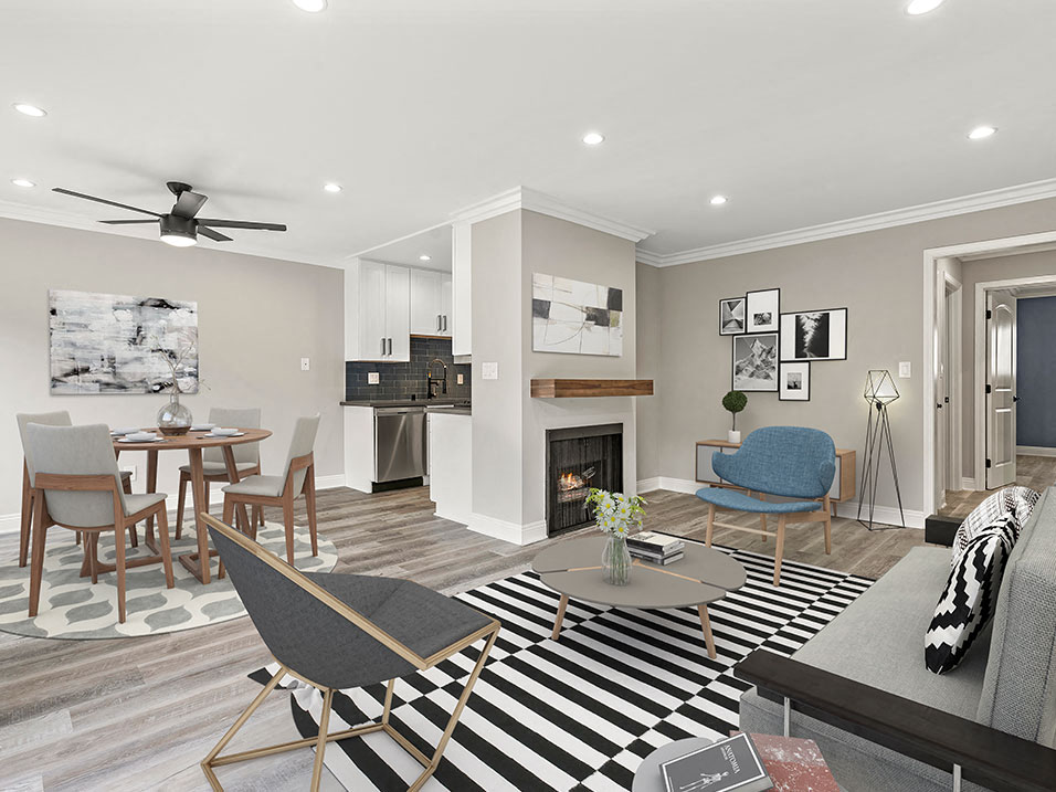 Living room with hardwood floors and view of dining room and kitchen.