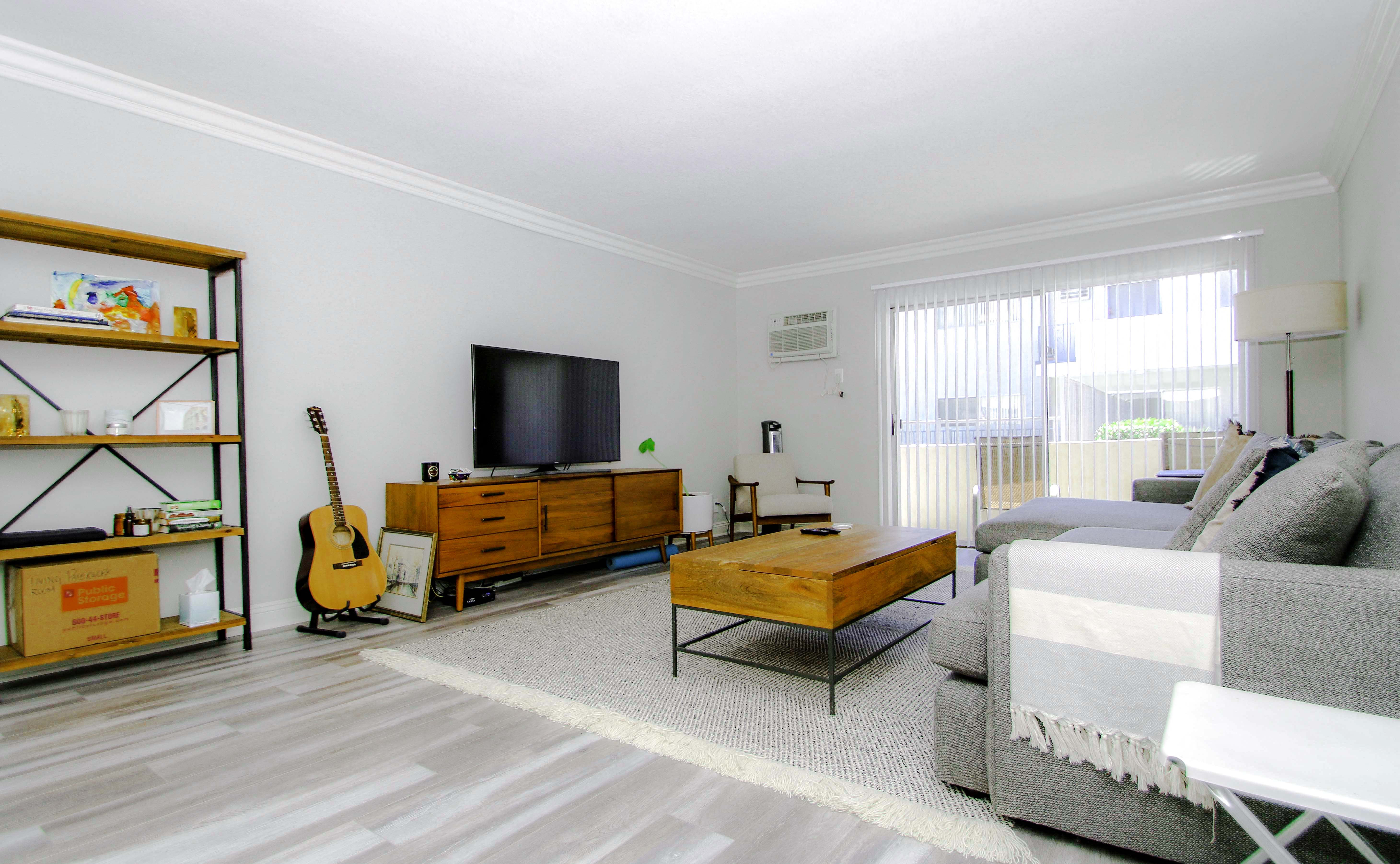 Living room with hardwood floor and large patio windows.