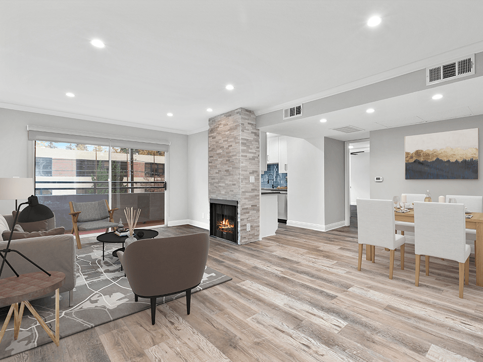 Hardwood floored living room with stone walled fireplace.