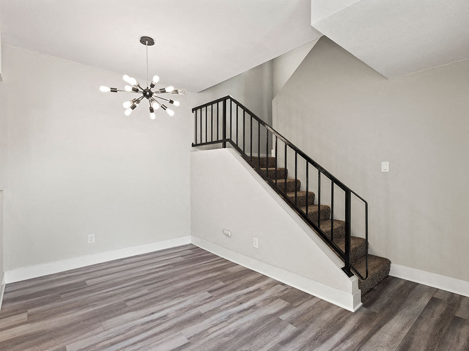 Living room with hardwood floor, fireplace, and Edison lighting.