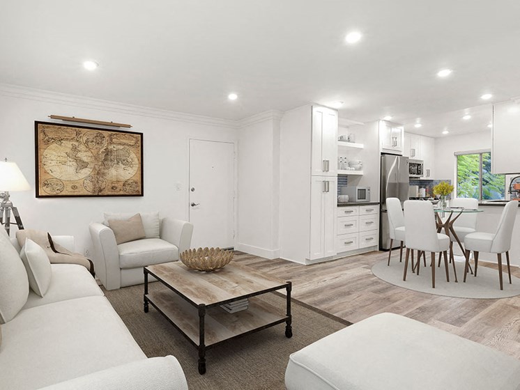 Hardwood floored living room with view of spacious kitchen.