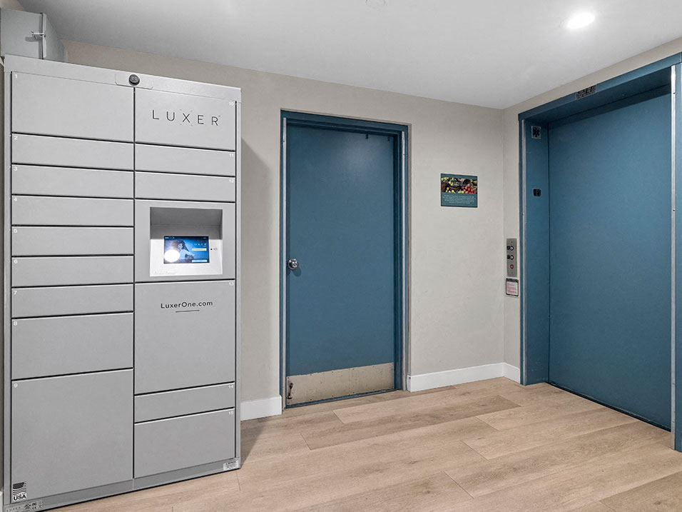 Secure package delivery lockers in elevator vestibule.