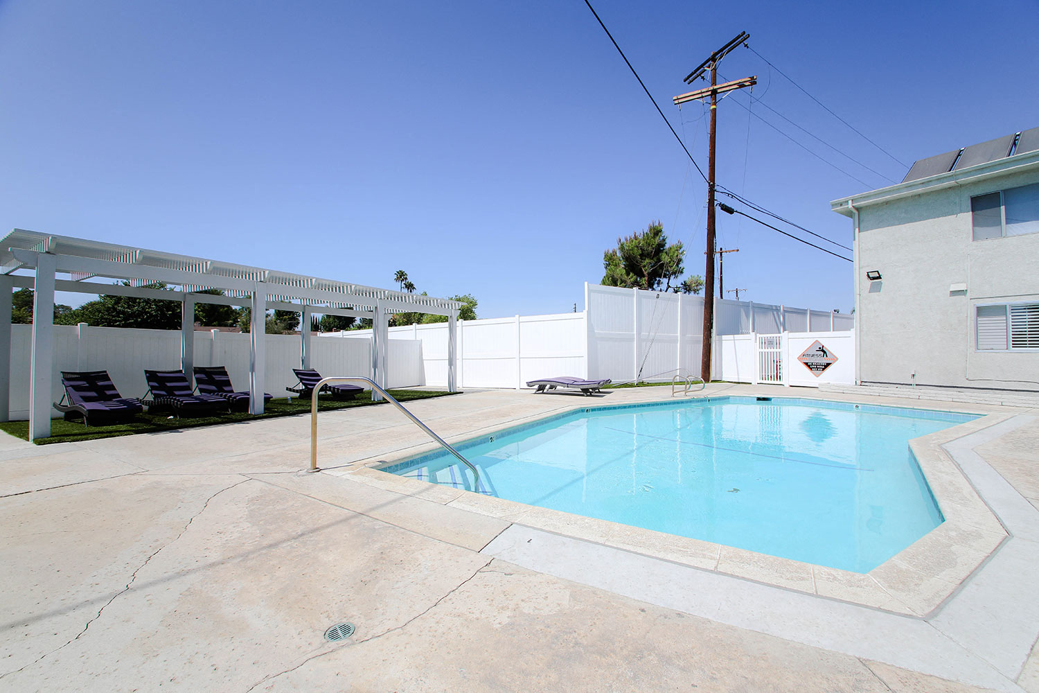 Gated pool with lounging area at Cedar Glen.