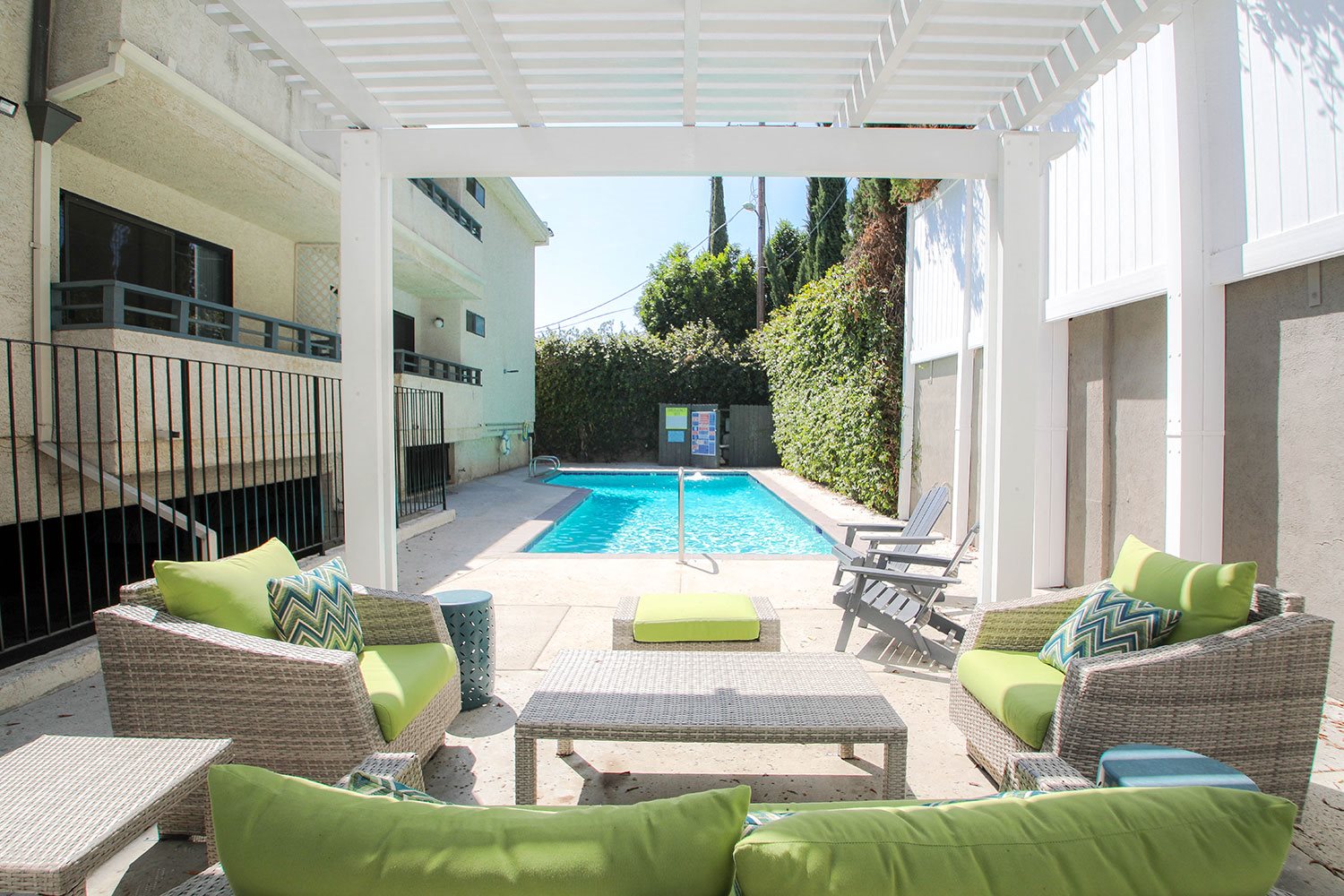 Exterior pool seating area with lounging space.