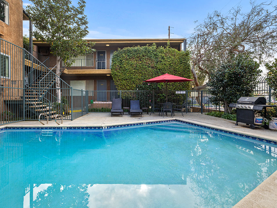 Fenced courtyard pool and BBQ area.