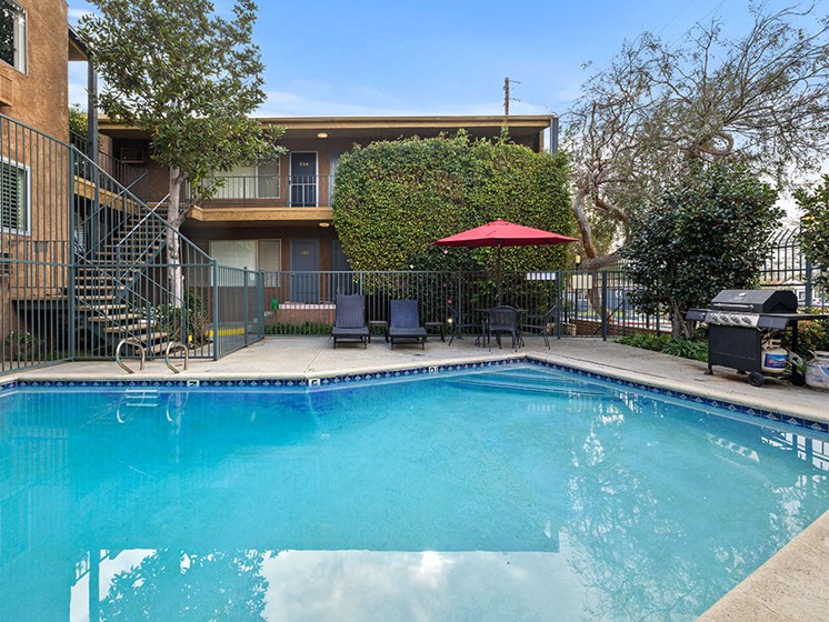 Fenced courtyard pool and BBQ area.