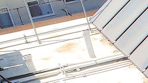Aerial view of gated community pool with lounging space.