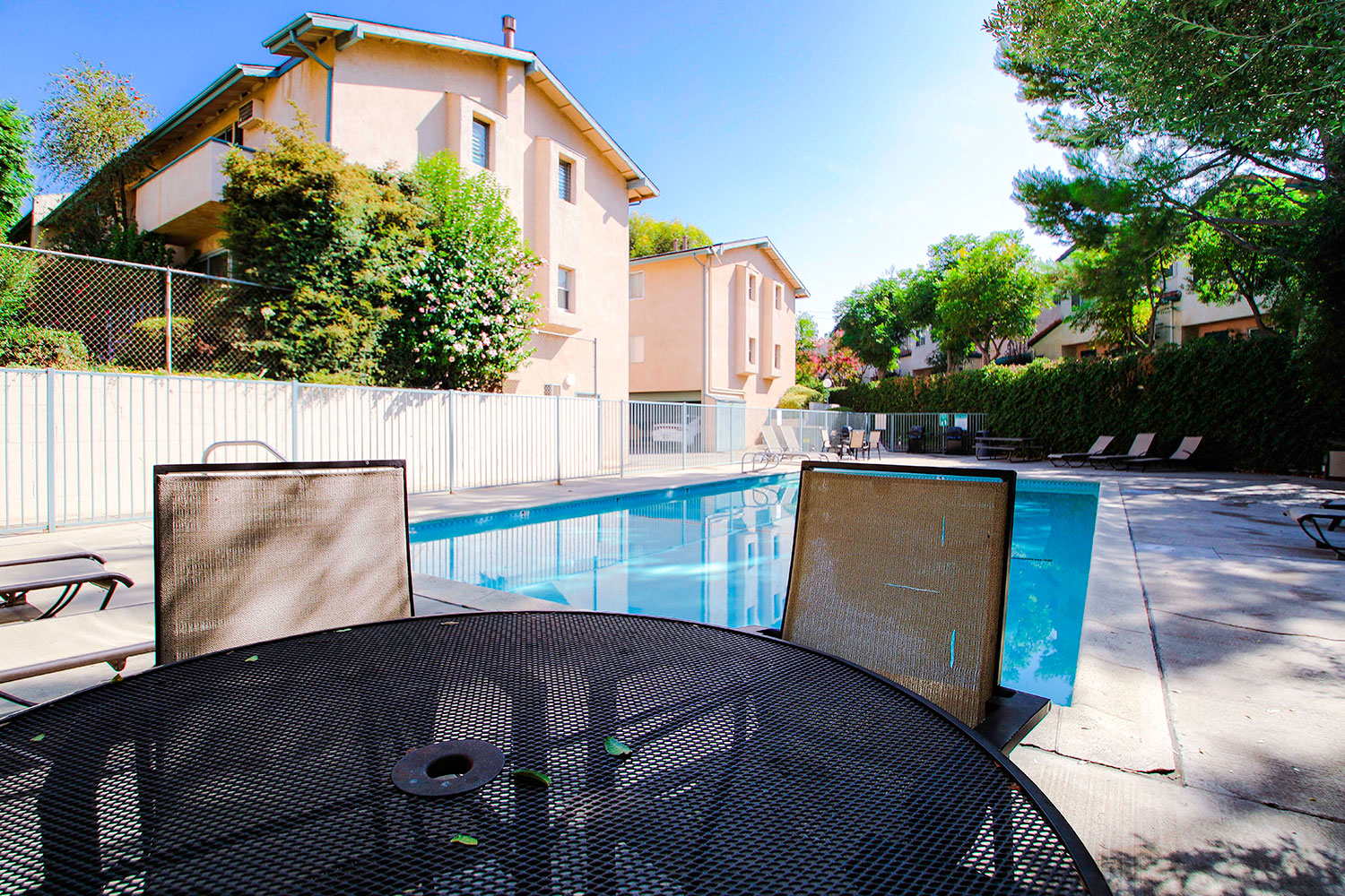 View of seating area by the pool at Olive View Gardens.
