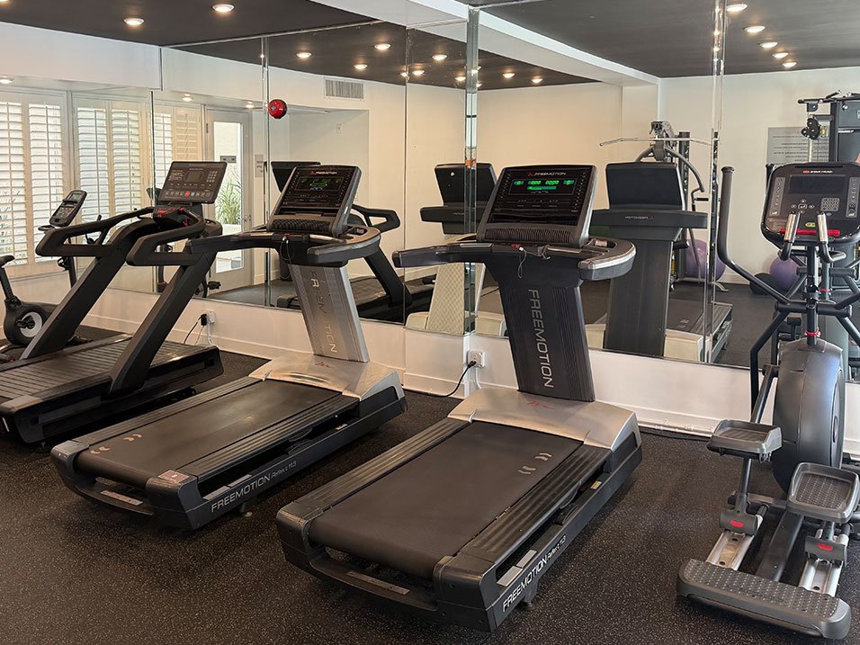 Fitness Center With Treadmills, Free Weights, and Bikes.