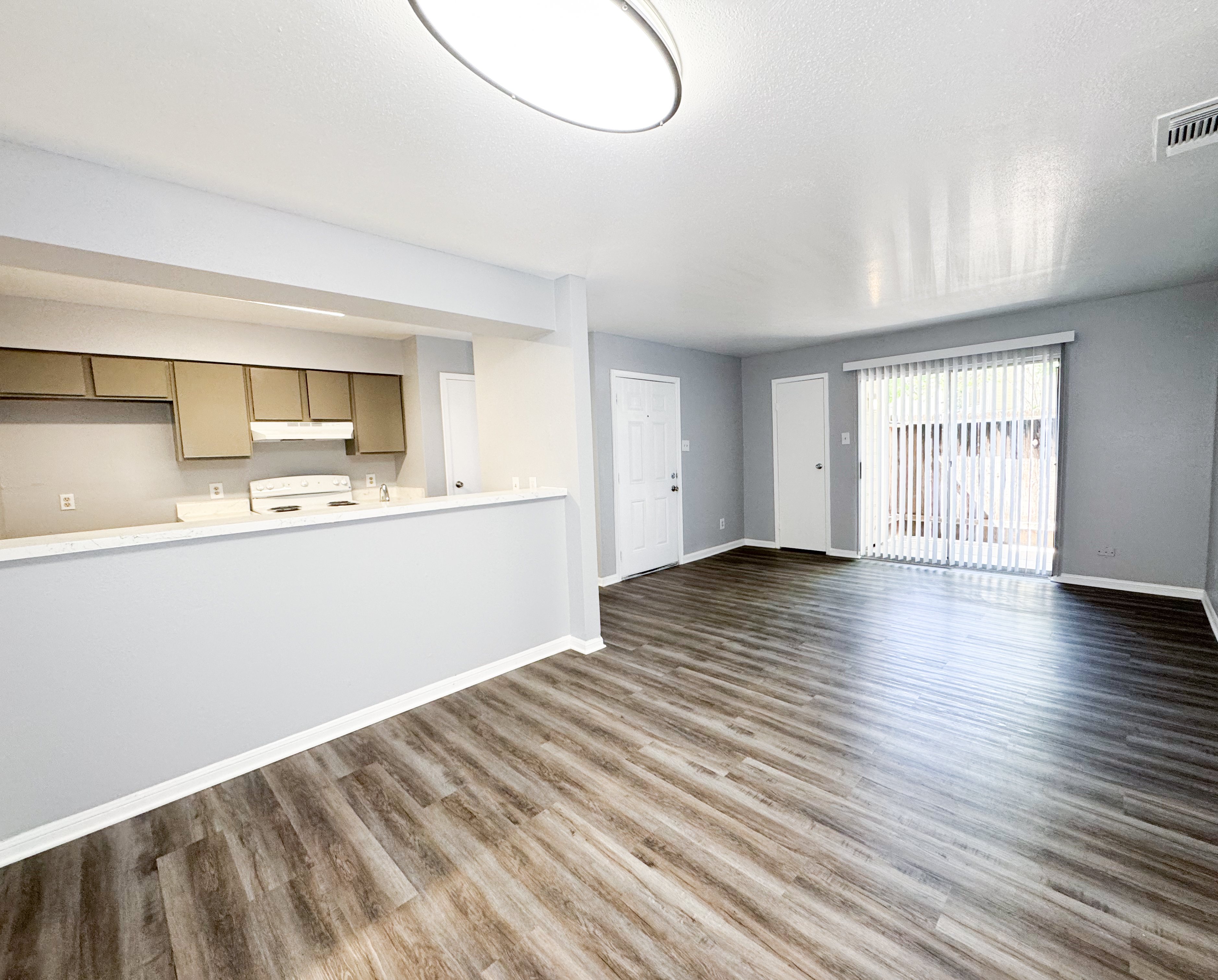 A room with wooden flooring and a white ceiling.