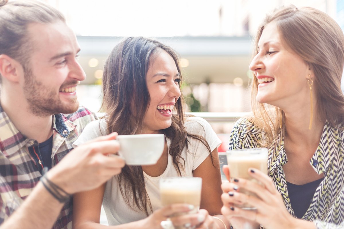 Three people enjoying a drink together.