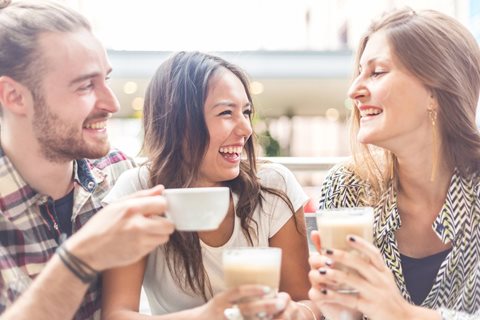 Three people enjoying a drink together.