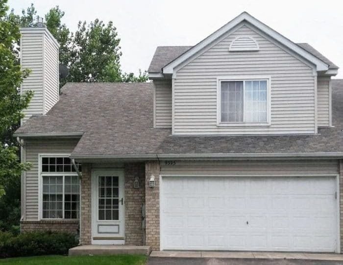 a white house with a white garage door,a white house with a white garage door