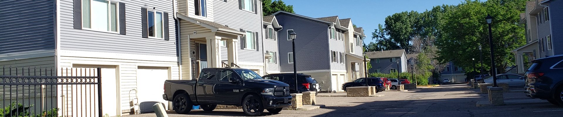 a street with cars parked in front of houses