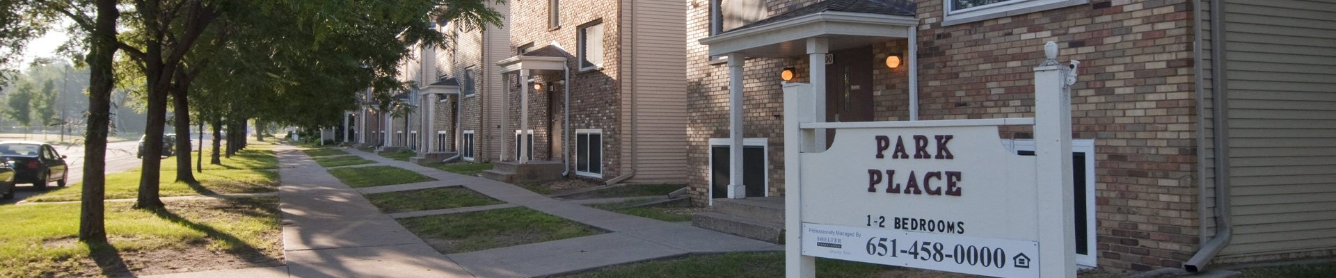 a sign that reads park place in front of a row of houses