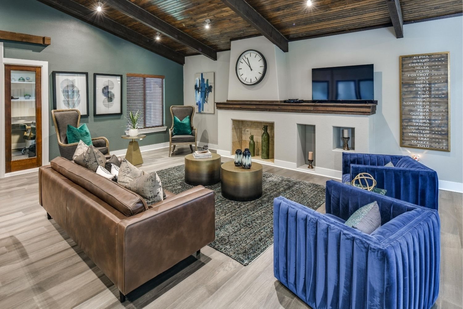 Inviting community lounge with fireplace feature wall, TV nook, and modern seating.