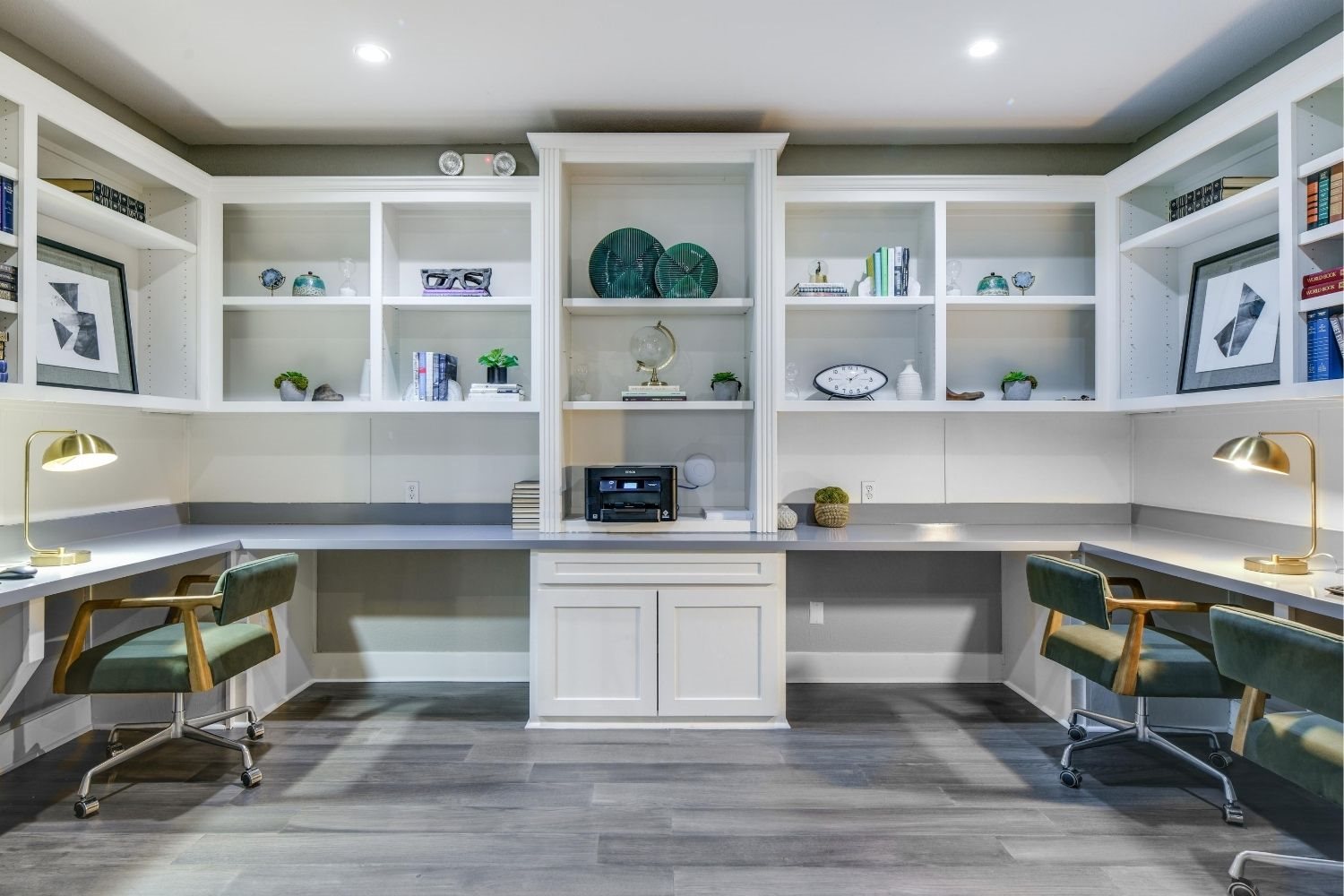 Business center with shared worktable seating, open shelving, and a bright, modern layout.