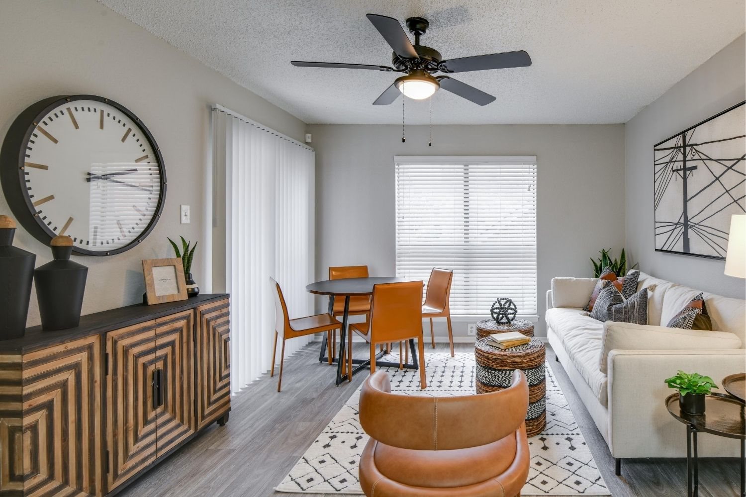 Open living area with round table, ceiling fan, and cozy seating.