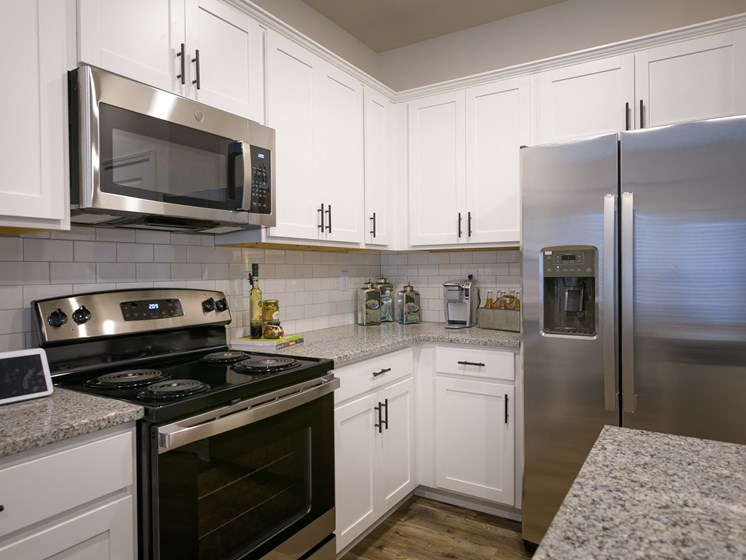 model kitchen with stainless steel appliances and designer cabinetry at Brighton Townhomes, Georgia