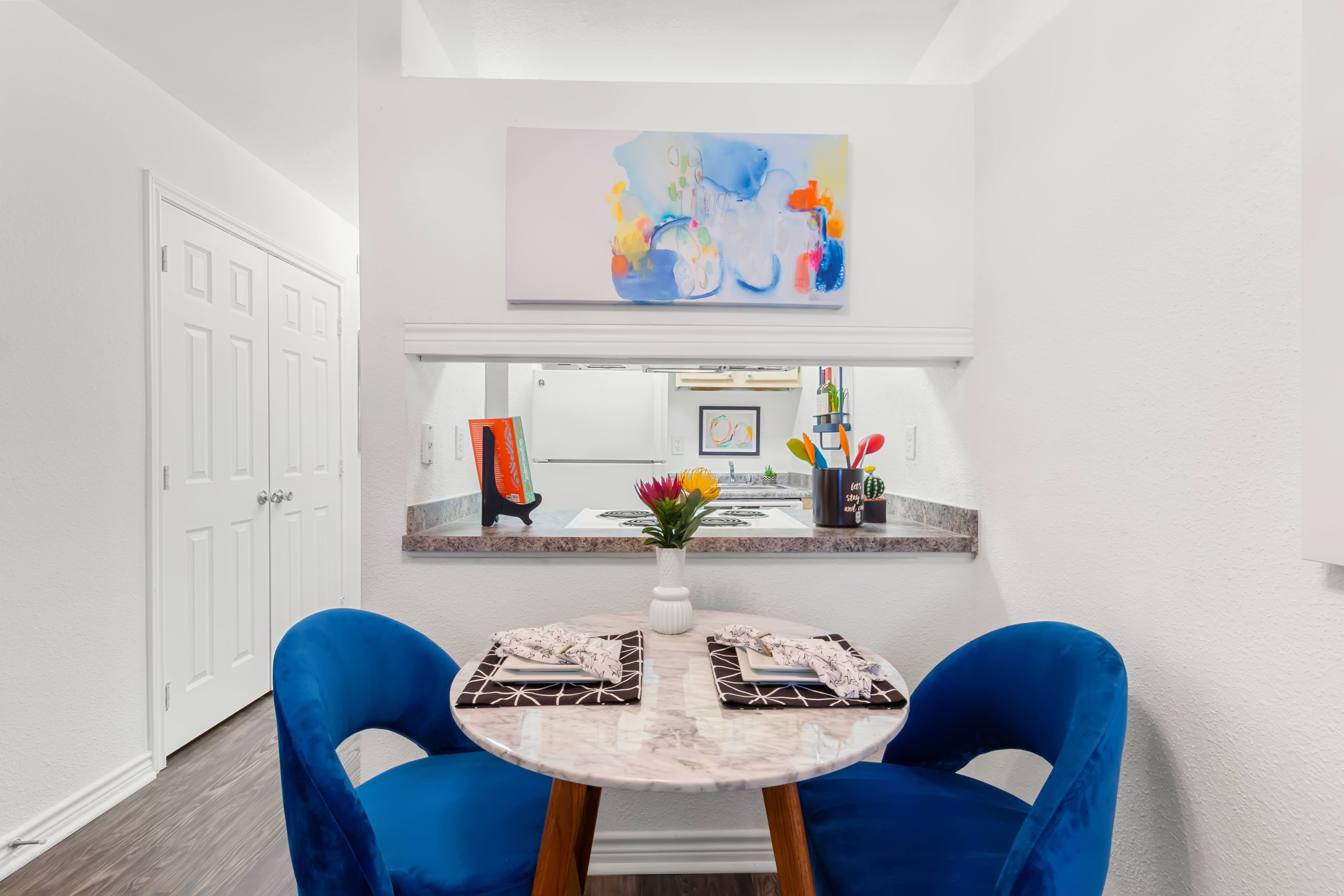 A dining room with a table and chairs.,A dining room with a table and chairs.