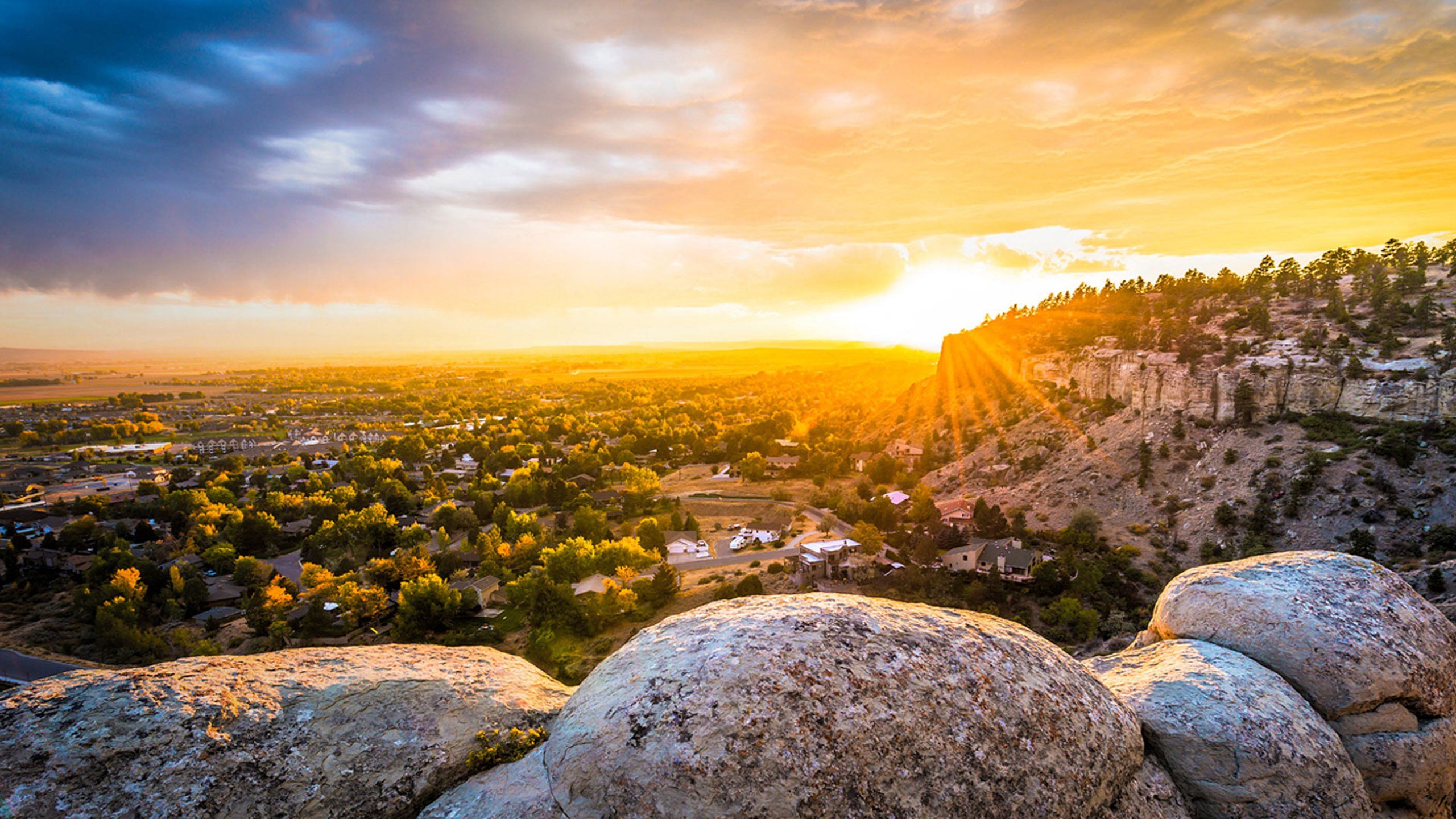 a view of the sunset over a city from a rocky hill at Rock Creek, Montana, 59102