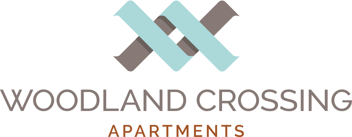 the logo for woodlands crossing apartments with the words woodland crossing apartments at Woodland Crossing , California, 95695