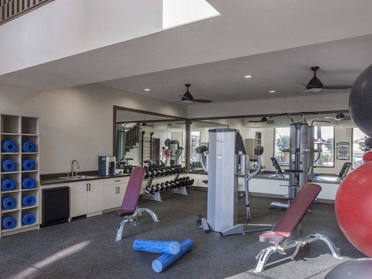 Fitness center with mats, weights, and other equipment and machines