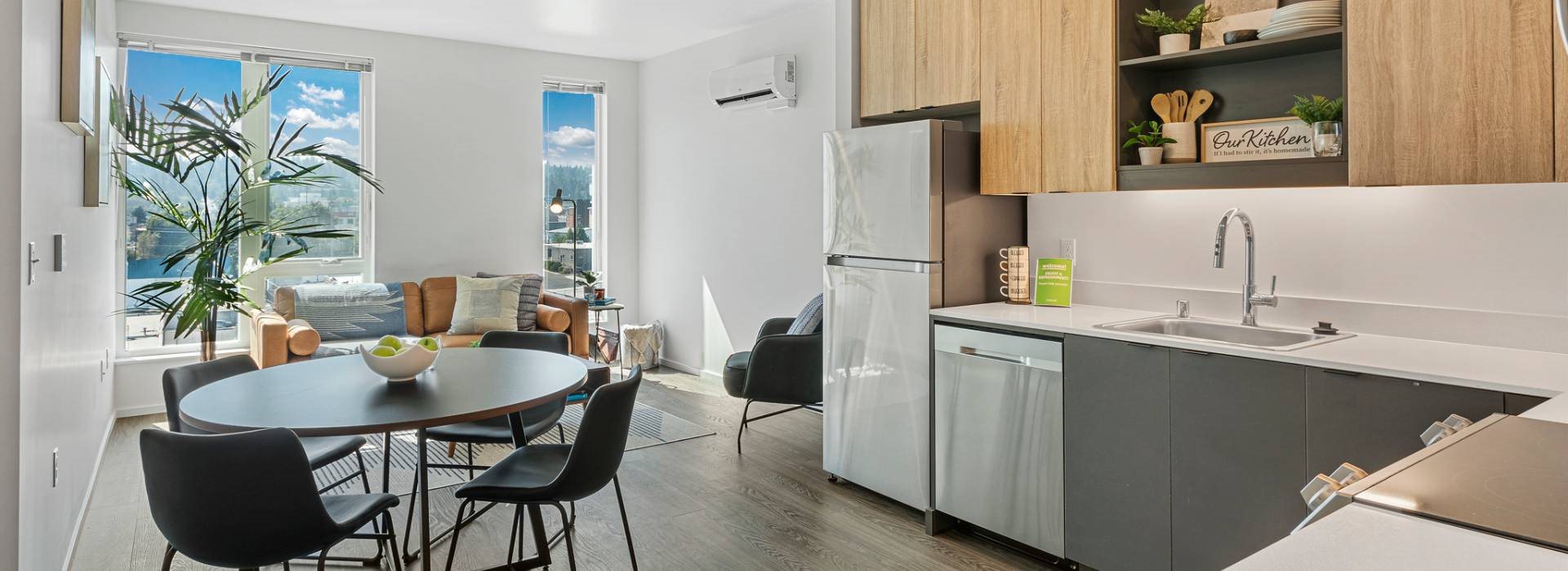 A modern kitchen with a dining table and chairs.